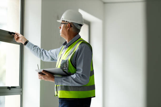 istock Professional senior engineer builder old man work looking at contract detail document paper 1427662054