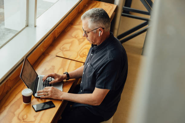 istock Businessman using laptop on desk in office 1427662091