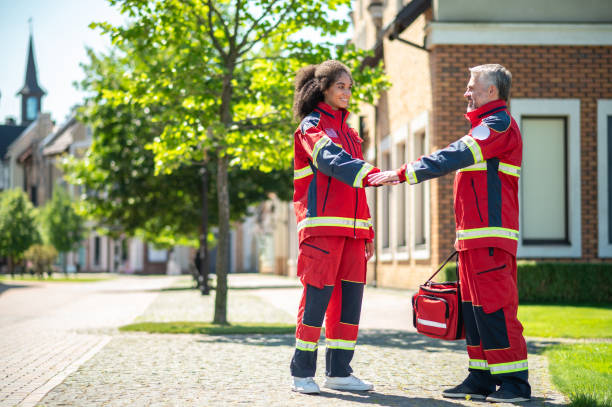 istock Cheerful paramedical staff shaking hands on the street 1427662430