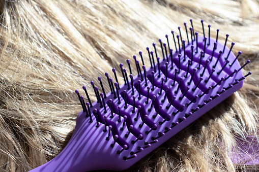 Comb and blond hair close-up