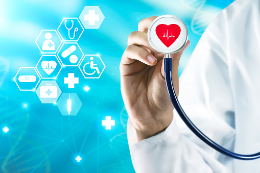 Heart health, healthcare business data graph and growth. Healthcare insurance. Doctor analyzing heart health with stethoscope and medical icons on the virtual computer screen and network connection
