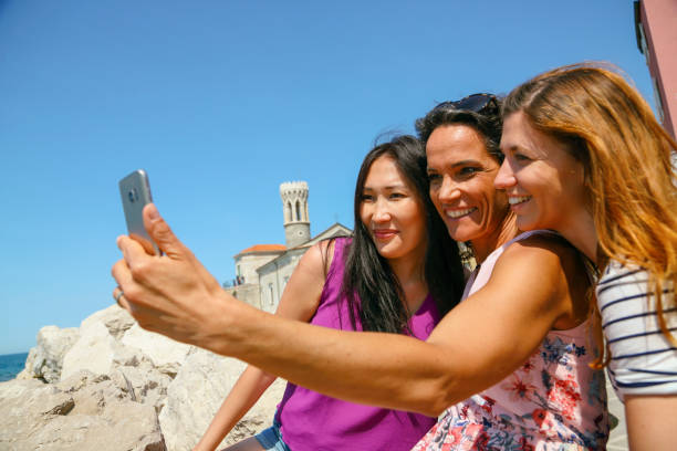 istock Mixed race female friends taking a selfie 1427666375