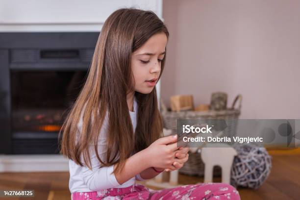 Tired Girl Starting Her Day With Smart Phone In Hand Stock Photo - Download Image Now