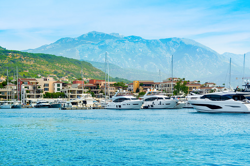 Sunset view of the yacht marina in Porto Montenegro with waterfront residences and  the beautiful promenade