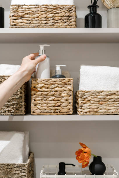 istock Woman take shower gel from bathroom shelf 1427671608