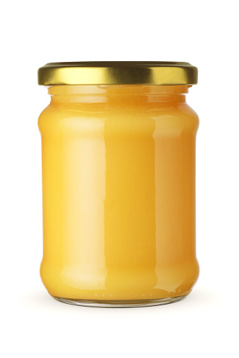 Jar of honey isolated on white background with clipping path.