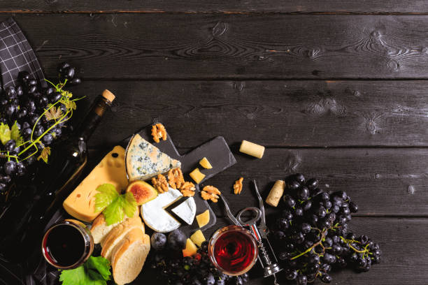 istock wine with branches of white grapes. On a wooden table. 1427677554