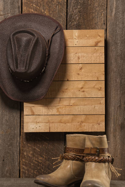 White cowboy hat hanging on wall with strong  window cross light light room for text