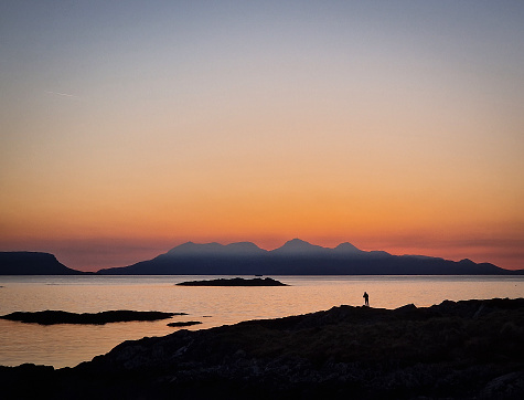 Wide angle shot of dusk at Arisaig, Scotland with person silhouette