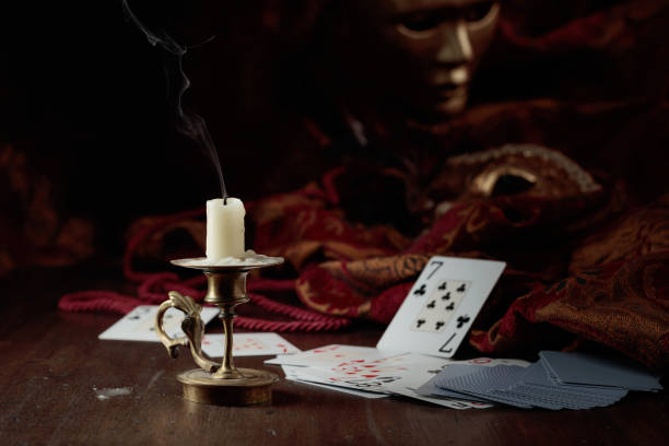 istock Still life with an extinguished candle, playing cards, and carnival masks. 1427680708