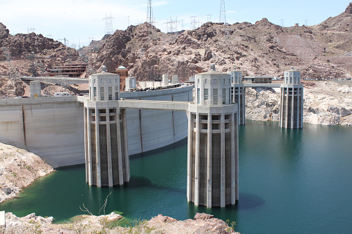 Boulder City, NV, USA - July 6, 2011: View of Hoover Dam's partially submerged intake towers and low water reservoir levels from Arizona side. Hoover Dam is located within Lake Mead National Recreation area.
