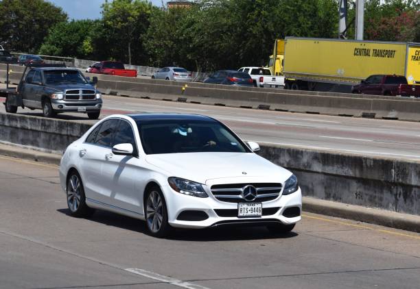 Dartmouth, Nova Scotia, Canada - March 13, 2011: Various Mercedes Benz vehicles in a row at a Mercedes/Smart dealership.  Identical models of Mercedes C-Class vehicles.  Focus on first automobile.