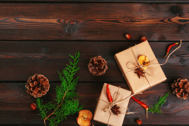 istock Christmas composition. Christmas gift, knitted blanket, pine cones, fir branches on wooden background. 1427683067