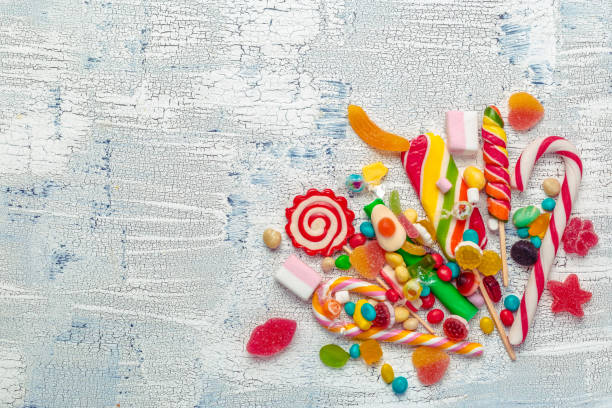 istock Colorful candies on wooden table background. 1427683140