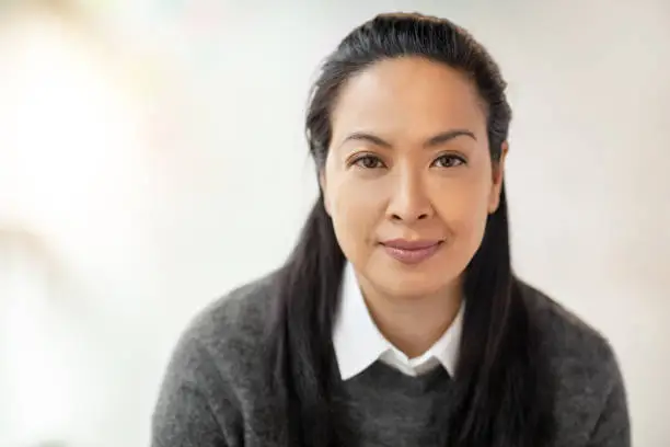 Portrait of multiracial Asian Hispanic Pacific Islander woman in modern office