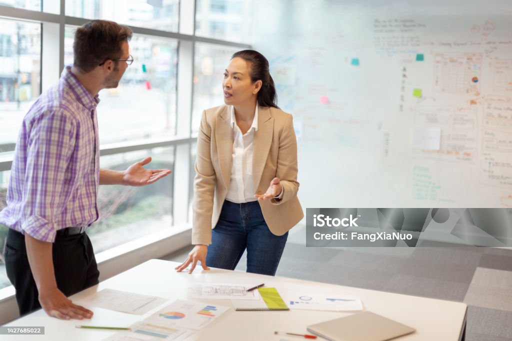 Multiracial work colleagues having meeting in modern business office Arguing Stock Photo