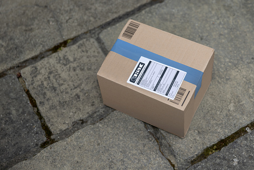 Close-up on a delivery package on the floor - online shopping concepts