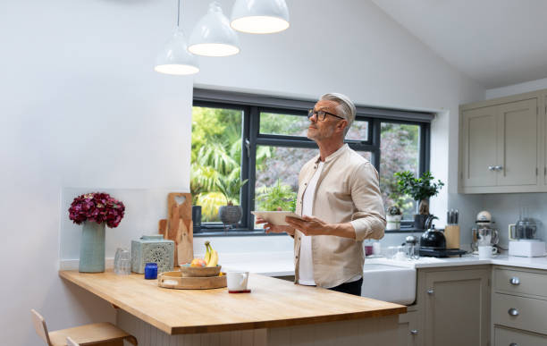 istock Man controlling the lights in his house using an automated system 1427687116