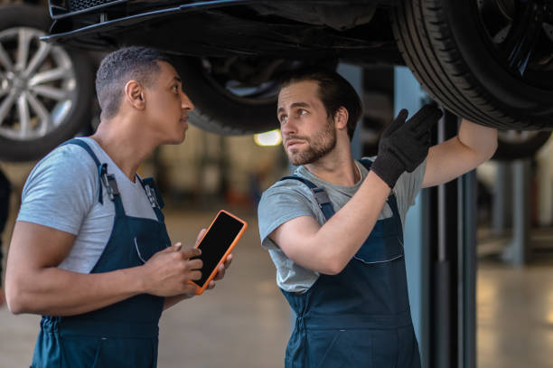 istock Skilled mechanics checking tires on the customer vehicle 1427687539