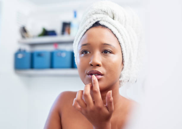 Morning skincare and black woman on mirror in bathroom check face for beauty. African american girl in apartment toilet room with facial or lips cleaning, easy skin routine and self love lifestyle Morning skincare and black woman on mirror in bathroom check face for beauty. African american girl in apartment toilet room with facial or lips cleaning, easy skin routine and self love lifestyle lips balm stock pictures, royalty-free photos & images