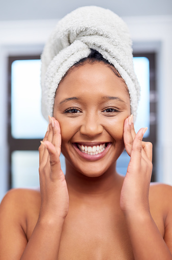 Face, skincare and happy black woman in bathroom with beautiful, smooth and clear skin. Girl portrait smile, perfect teeth and glowing skin after facial spa treatment for beauty, body care and health