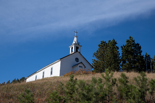 Old hilltop country church building in mining ghost town in northern Montana in western USA.