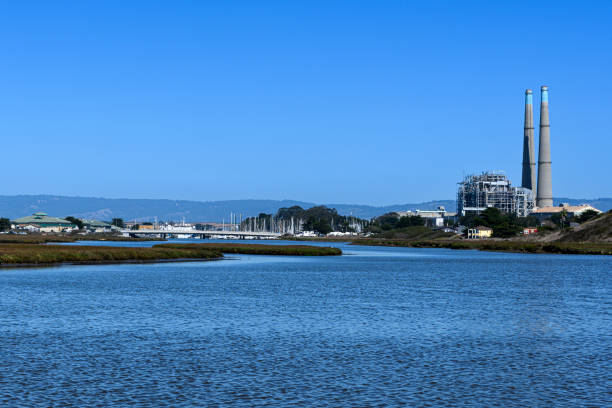 Wide view of Salinas River at moves toward Moss Landing on it's way to the Pacific Ocean.  In the background to the local natural gas powered energy plant.\n\nTaken near Moss Landing California, USA