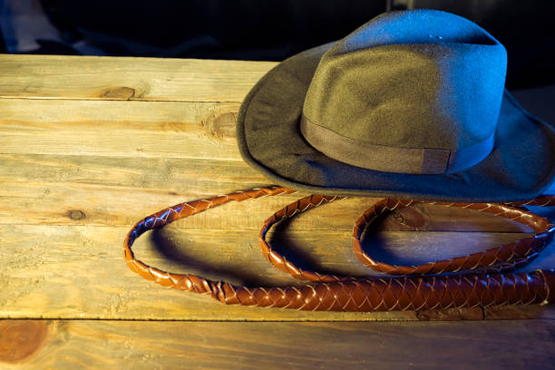 travel concept background indiana jones style hat and the whip - bullwhip imagens e fotografias de stock