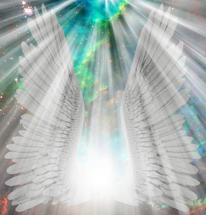 a guardian angel in a blue robe with a book in the snow on a background of multicolored brilliant lights. christmas decoration. postcard. Space for text. Copy space