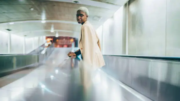 Photo of Black girl on the metro travelator