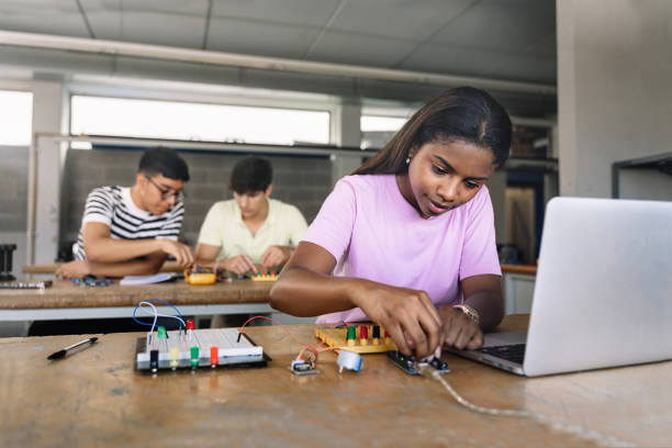 istock African American High School teenage Student programming electronics circuit board in the science technology workshop - Learning Digital Innovation in Education 1427697413