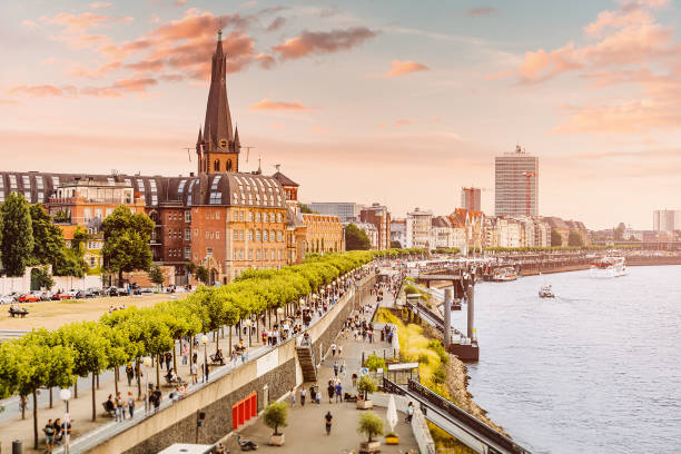 Sunset view of Dusseldorf city old town or Altstadt. Promenade on the banks of Rhine river. Travel and visit attractions in Germany. Popular city, center of Rheinland and Westphalia stock photo