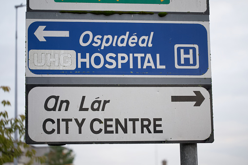 Darlington, England - July 31, 2015: Darlington Memorial Hospital sign, front park, visitor car park, and main building in the background. The signpost shows the directions for the visitor and disability car park and the emergency department as well mentioning that the site is smoke free among other things.