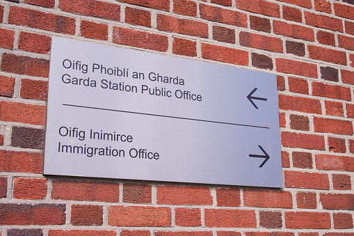 Close up of Garda Station Public Office and Immigration Office sign on building exterior