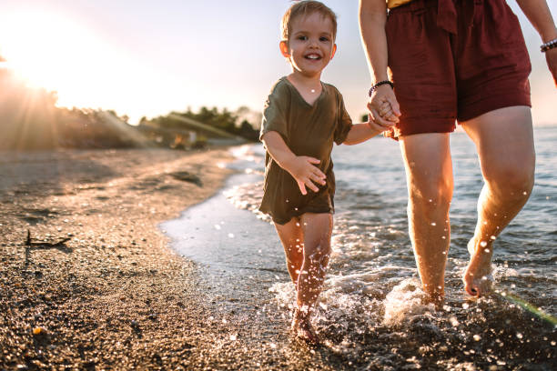 istock Cheerful boy running at beach on summer day in sunset 1427707504