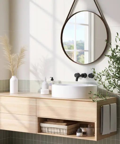 Modern and luxury design of wooden bathroom vanity with white round ceramic washbasin and mirror with sunlight from window on white and green tile wall for personal care and toiletries product display