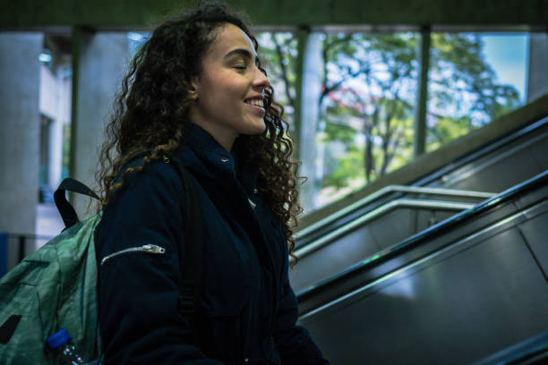 istock A young woman walking up the subway escalators 1427713080