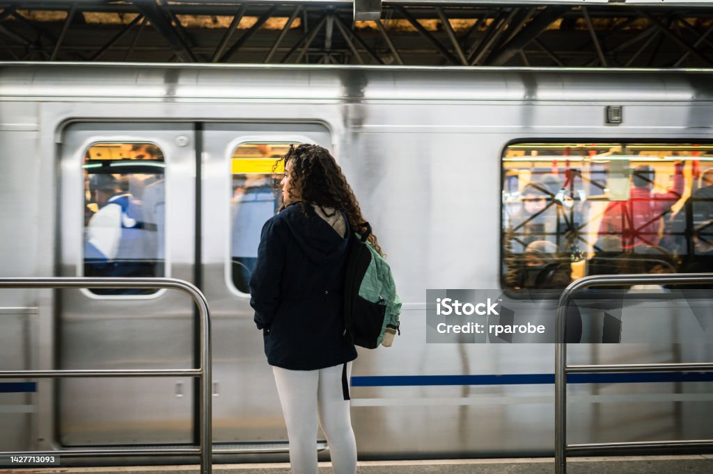 The subway arrived A young woman on the platform and the subway arriving Subway Stock Photo