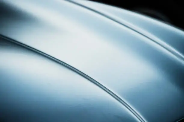 Abstract defocused and blurred photo of a luxury car hood