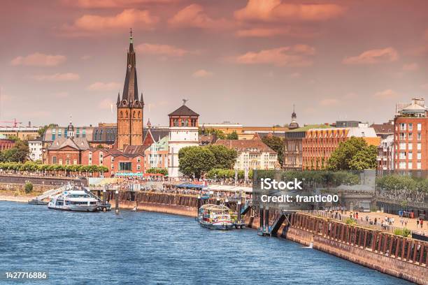 Recognizable Architectural Towers Of The City Of Dusseldorf And Transportation Waterway Of The Whole Of Germany Rhine River Along Which Large Barges And Small Ships And Boats Scurry Stock Photo - Download Image Now