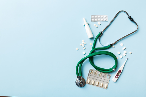 Medical background. Many different various medicine tablets or pills on the table with stethoscope. Close up. Healthcare pharmacy and medicine concept.