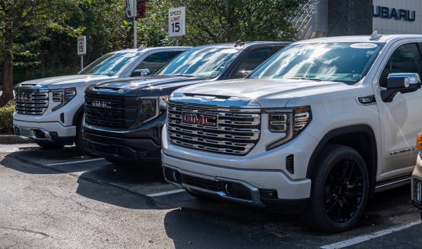 A dealership in Monroeville, Pennsylvania, USA with three GMC trucks for sale stock photo