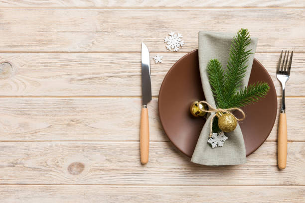 istock Christmas table place setting with christmas decor and plates, kine, fork and spoon. Christmas holiday background. Top view with copy space 1427719776