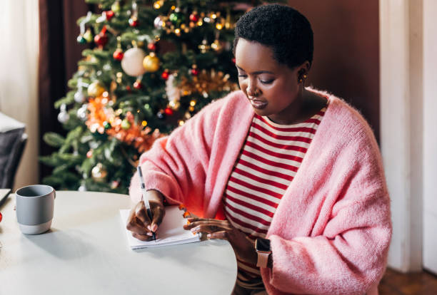Woman Writing Her New Year's Resolutions