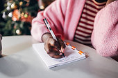 istock Woman Writing New Year's Resolutions 1427720072