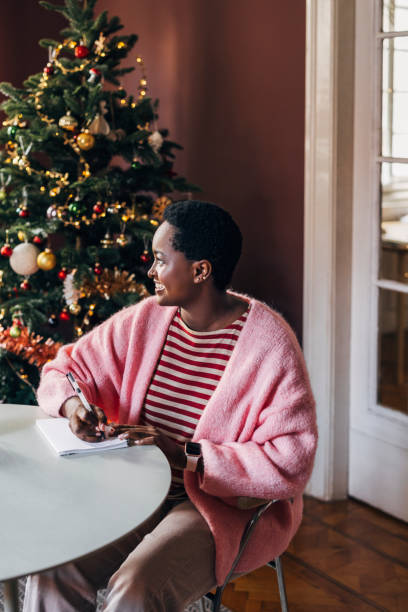 istock Woman Writing Her New Year's Resolutions 1427720077