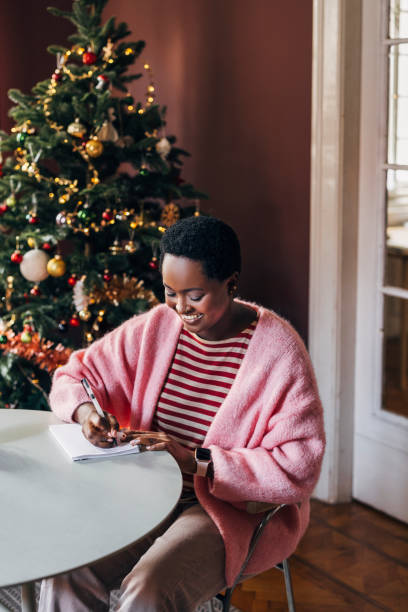 istock Woman Writing Her New Year's Resolutions 1427720099