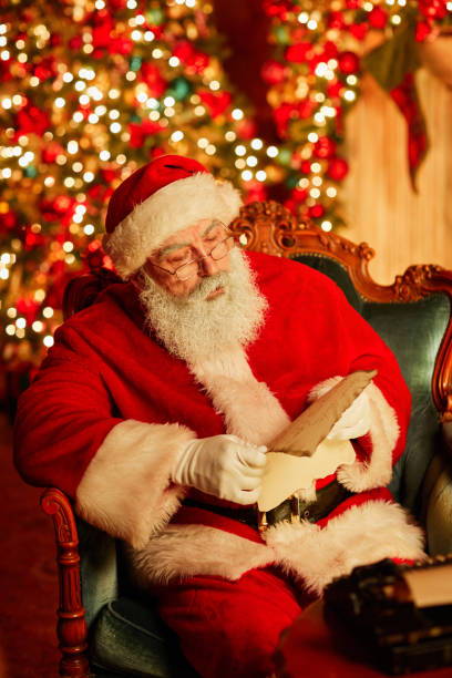 istock Traditional Santa Claus Reading Letter 1427748499