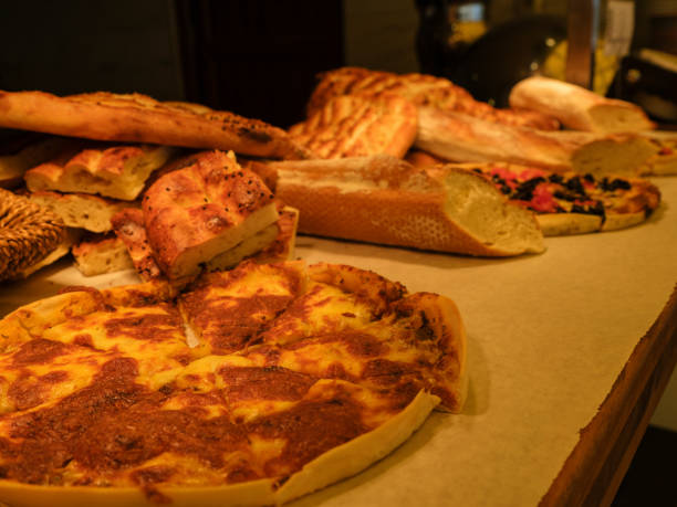 istock fresh pizza and breads in a bakery 1427750452