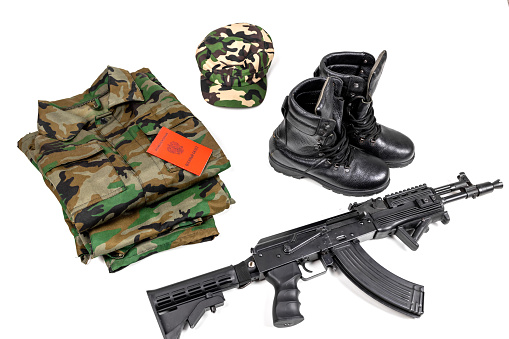 Kalashnikov assault rifle, military uniform and documents of a citizen of the Russian Federation on a white background. Text in Russian MILITARY ID